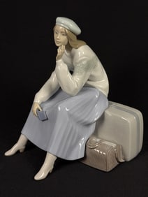 Lladro Porcelain Figurine 6709 Pensive Traveler 11 inches tall by 10 inches wide by 9 inches deep.