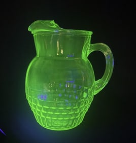 Uranium Glass Pitcher 9 inches tall 8 inches wide. No cracks. Some light scuffs and scratches.