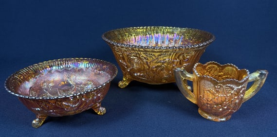 Collection of Orange Carnival Glass 2 footed bowls measuring 7 x 3 and 10 by 5 inches. Handled mug