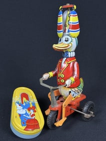 Vintage Tin Toys Noise Maker Wind Up Duck Bike Noise maker by Kirchhof measuring 4.5 by 2.5 inches.