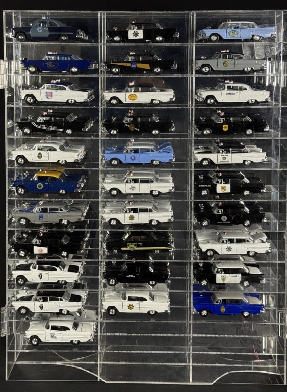 1950s Diecast Police Cars Collection 1/43 Scale 31 cars by Road Champs in acrylic mirror backed: 31 cars by Road Champs in acrylic mirror backed case. Case has some damage see photos. 23.5 x 18 x 2.5 inches.