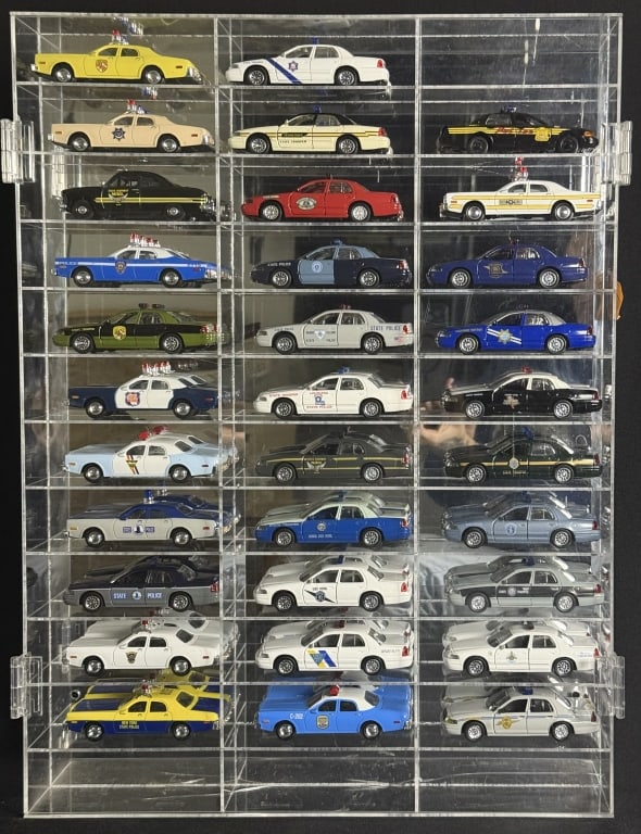 Diecast Police Cars Collection 1/43 Scale 32 cars in acrylic mirror backed case. Case has some: 32 cars in acrylic mirror backed case. Case has some cracks see photos. 23.5 x 18 x 2.5 inches.