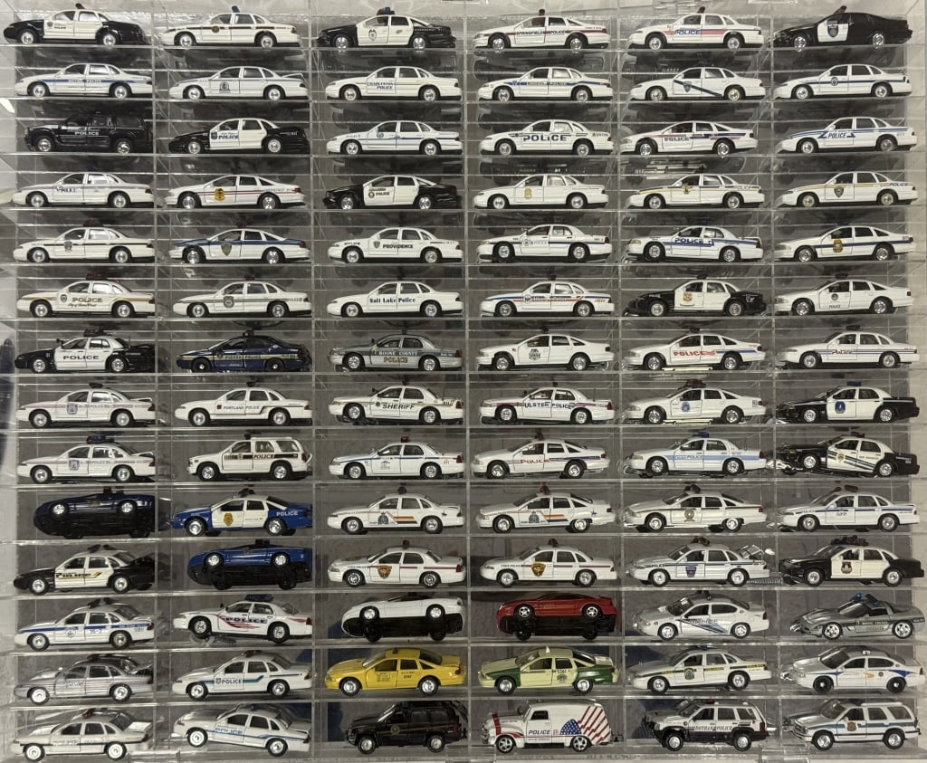 Diecast Police Cars Collection 1/43 Scale Description 84 cars in acrylic mirror backed case. 32.5 x: Description 84 cars in acrylic mirror backed case. 32.5 x 27 x 2.5 inches. Cars in good condition. Case is free from cracks.