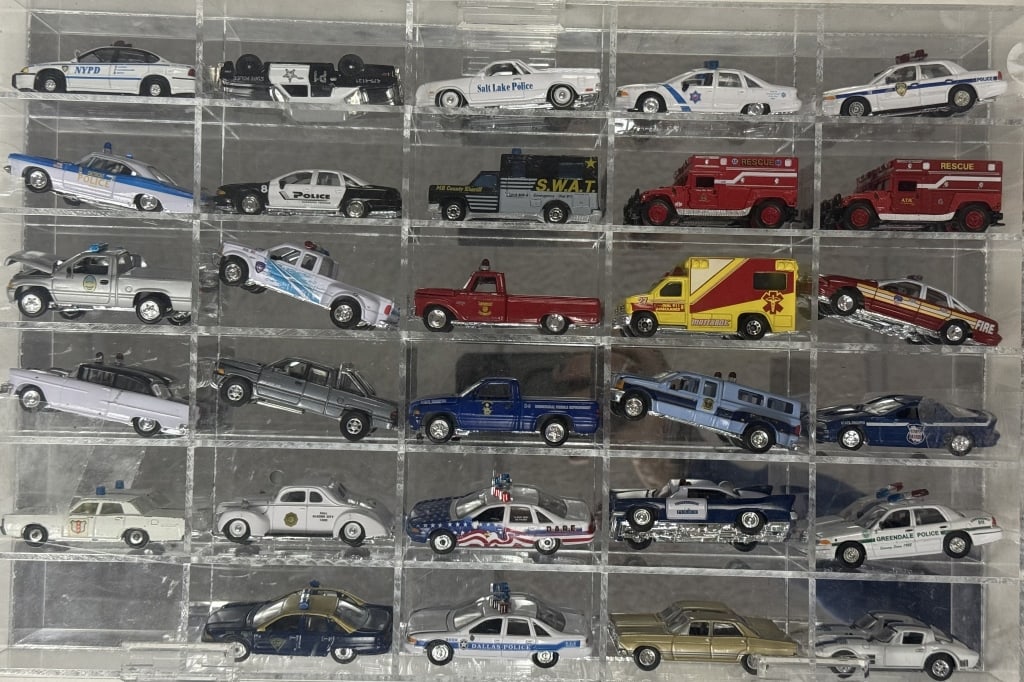 Diecast Police & Rescue Cars Collection 1/64 Scale 29 cars in acrylic mirror backed case. 16 x 11 x: 29 cars in acrylic mirror backed case. 16 x 11 x 2.5 inche s. Cars in good condition case is free from cracks.