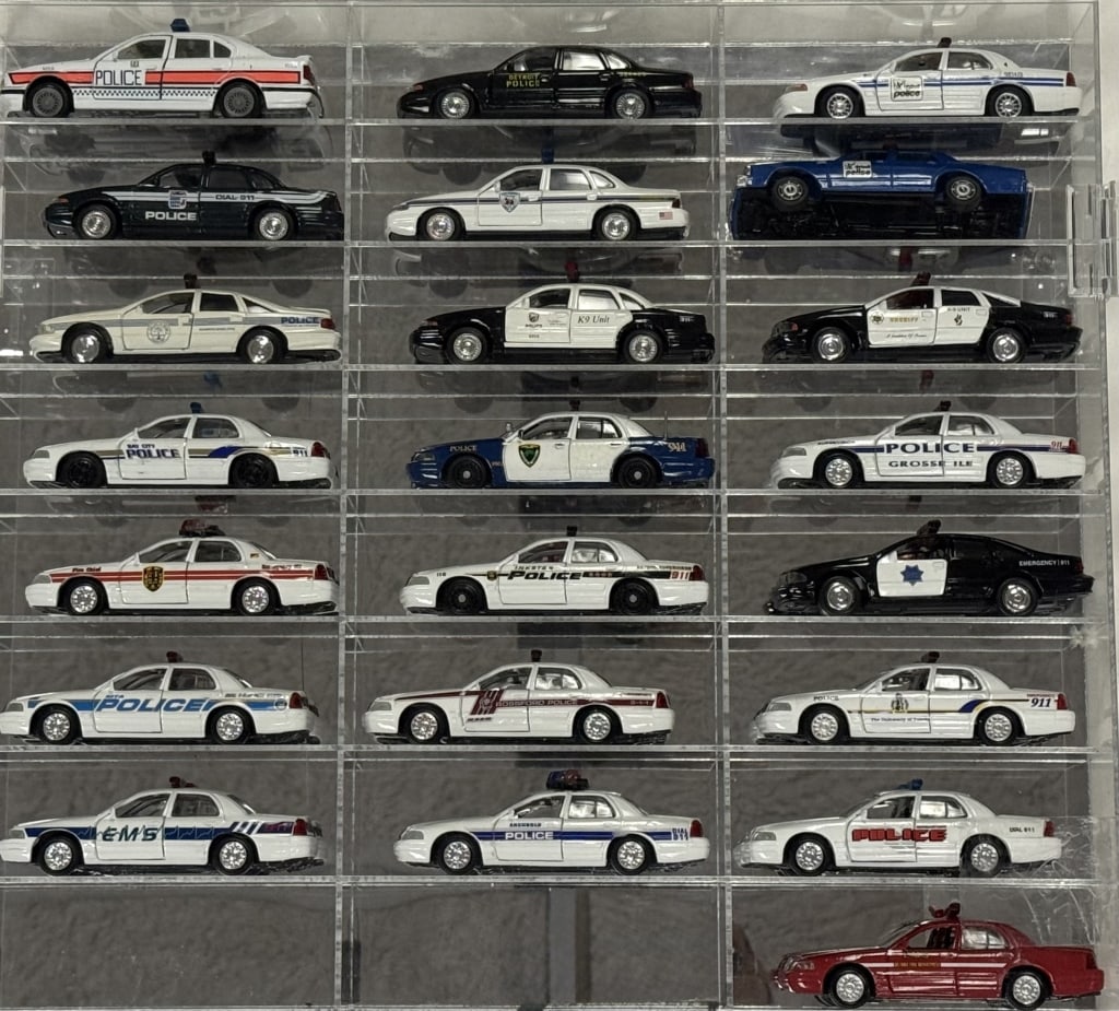 Diecast Police Cars Collection 1/43 Scale 22 cars in acrylic mirror backed case. Cars in good: 22 cars in acrylic mirror backed case. Cars in good condition Case free from cracks. 23.5 x 18 x 2.5 inches.