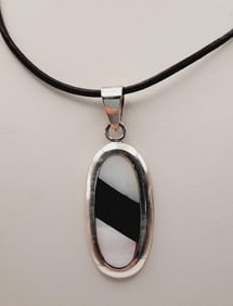 925 Sterling Onyx & Mother-Of-Pearl Pendant Necklace Necklace is 22". Weighs 9.1 grams.