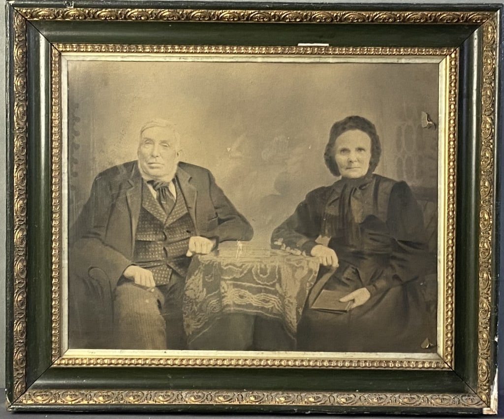 Antique Photo in Frame Sheppard Grandparents Antique photograph from the early 1900's of an elderly: Antique photograph from the early 1900's of an elderly couple seated at a table. Back is labeled Sheppard Grandparents. A few holes in photo, some lacquer chips to frame. Artwork with frame is 24 1/2