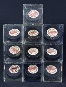 Detroit Red Wings Signed Hockey Puck Collection 10 pucks in acrylic casss. 9 signed. signatures