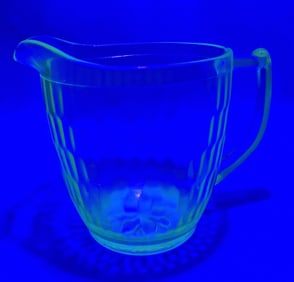 Vintage Green Vaseline Glass Pitcher 5.5 inches tall. Very small chips around rim and on handle.