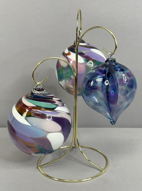 Handblown Glass Ornaments & Brass Stand Three multi colored glass ornaments, two orbs and one heart: Three multi colored glass ornaments, two orbs and one heart shaped. Stand is 11 1/2 inches tall. Orbs are 13 1/2 inches around, heart is 4 inches across. All are unsigned.