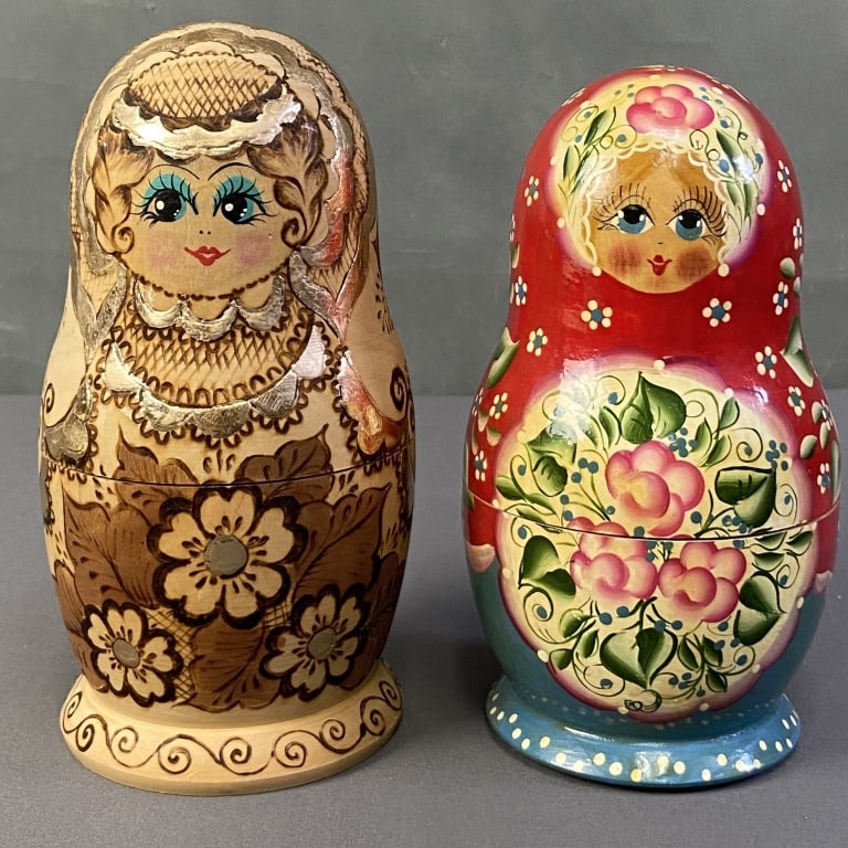 Two Vintage Matryoshka Russian Nesting Doll Sets Two handpainted Russian Nesting dolls, signed by: Two handpainted Russian Nesting dolls, signed by the artist and dated 1995 and 1996. One body from the red set is stuck inside other body. Each set contains 7 dolls. Largest dolls are 7 1/2 and 8 inch