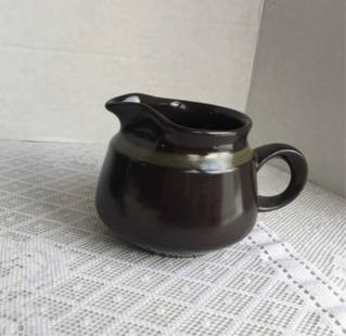 Franciscan Ware Earthenware Madeira Creamer Vintage creamer or gravy boat in the Madeira pattern by: Vintage creamer or gravy boat in the Madeira pattern by Franciscan Ware of California. Beautiful dark chocolate brown glaze with a thin green trim. Mark is faded but still visible. Small pitcher is in