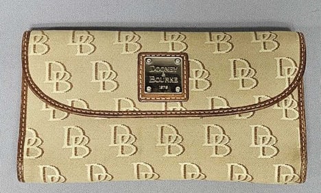 Dooney & Bourke Wallet Small stain on front corner and pens marks on the inside.