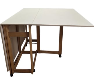 White Wooden Dual Drop Leaf Table on Wheels Measures 40 x 35 inches tall x 72 inches long when both