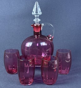 Vintage Bohemian Cranberry Glass Decanter Set With 4 glasses. Decanter measures 9 x 5 x 4 inches.