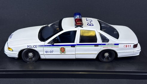 UT 1/18 Scale Chevrolet Caprice Police Car Brossard with case. Case measures 13 x 6 x 5.25 inches.