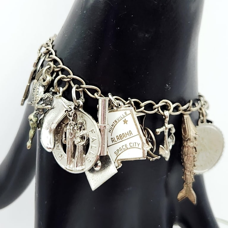 Vintage Sterling Charm Bracelet Bracelet is: Bracelet is 6". Weighs 40 grams. Most, but not all, of the charms are sterling.