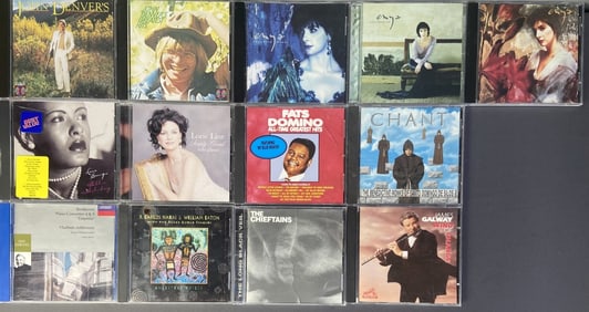Mystery Lot CDs Enya, John Denver, Billie Holiday Lot of thirteen compact discs with cases. CDs sold