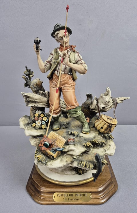 Capodimonte Porcellane Principe Figurine II Pescatore The Fisherman: Pescatore The Fisherman 12 inches tall. Chips throughout, fisherman’s red tie, on some leaves and grass. Please see images for details regarding the condition.