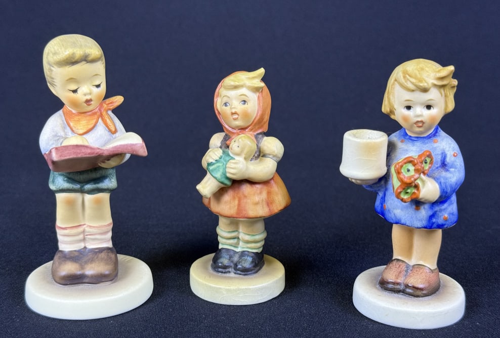 Hummel Figurines 115 239B 2087B Girl With Nosegay #115 stands 3.5 inches tall. Some crazing. #239 B: Girl With Nosegay #115 stands 3.5 inches tall. Some crazing. #239 B Girl With Doll stands 3.25 inches tall. Some crazing. Honor Student #2087 B stands 3.75 inches tall. Free from damage.