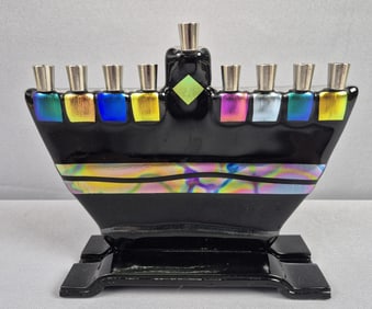 Signed Colorful Glass Menorah Unknown signature. Measures 8 x 7 inches tall. Free from damage.