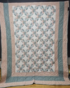 Vintage Double Wedding Ring Pattern Quilt Measures 88 x 65 inches. Small stains. Corner fabric torn.