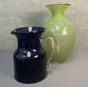 Art Glass Pitcher and Vase Purple art glass pitcher with clear handle, unmarked. Pitcher is 8 1/8