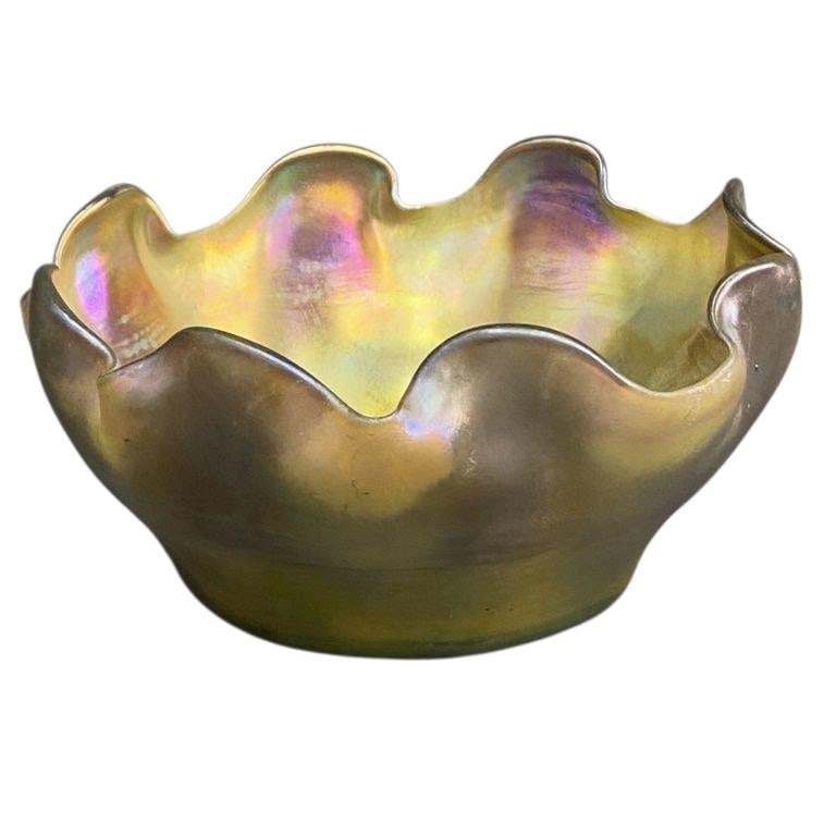 LC Tiffany Favrile Catchall Bowl Small bowl with ruffled rim in a gold iridescent color. Signed LCT: Small bowl with ruffled rim in a gold iridescent color. Signed LCT on the bottom. Clean, no chips or cracks. Bowl is 2 1/4 inches tall, 4 3/4 inches in diameter.