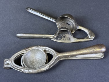 Antique Cast Iron Lemon Squeezers 2 citrus squeezers measuring 10 x 3 x 1 inches and 8.5 x 2 x 2