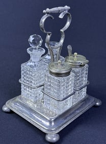 Cut Glass Silverplate 4 pc Cruet Condiment Set Caddy measures 5.5 x 5.75 x 6.75 inches.