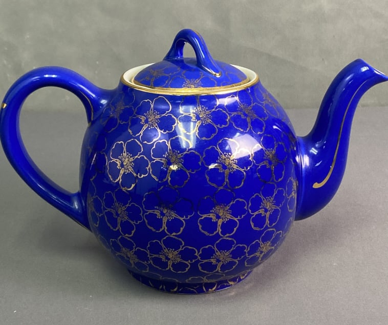 Hall Cobalt French Flowers Teapot Deep blue teapot decorated by gold flowers resembling dogwood: Deep blue teapot decorated by gold flowers resembling dogwood blossoms. Marked Hall 12 Cup Made in USA. No chips or cracks. Teapot is 7 1/2 inches tall with lid.