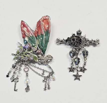 Vintage Kirks & Folly Fairy & Celestial Brooches Including a Kirks Folly celestial-themed brooch: Including a Kirks Folly celestial-themed brooch with a crescent moon, stars, and dangling crystal beads Also, a Kirks Folly silver-tone fairy pin with enamel and rhinestones.For the best shipping rate