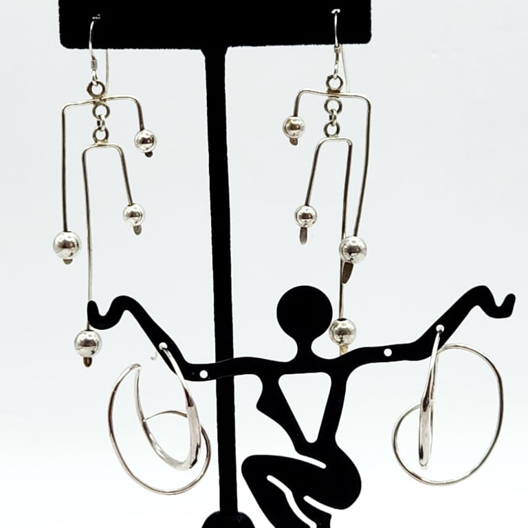 925 Sterling Abstract Dangle & Abstract Hoop Earrings: Earrings Signed Signature is illegible possibly George Jensen?? Lot weighs 7.9 grams.For the best shipping rates, please select "Self-Arranged." Once you've done this, you will automatically be added