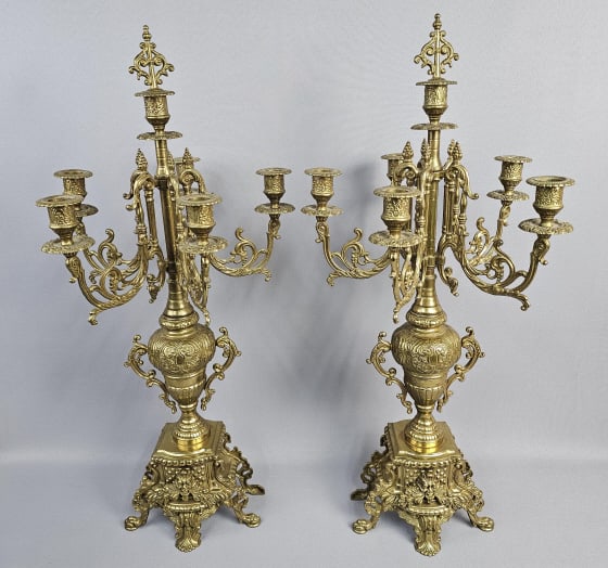 Antique Baroque Style Candelabras Set of Two Two candelabras in an ornate Baroque style. Made of: Two candelabras in an ornate Baroque style. Made of gilt bronze, very heavy. Both are unmarked, each holds four candles. Candelabras are each 27 inches tall. For the best shipping rates, please select