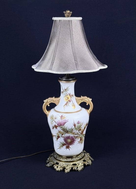 Vintage Hand Painted Thistle Glass Lamp Glass urn shaped table lamp with brass base. Hand painted: Glass urn shaped table lamp with brass base. Hand painted thistle flowers on both sides, gold gilt painted handles. Works great, lampshade is not original. Lamp with shade is 29 1/2 inches tall.For th