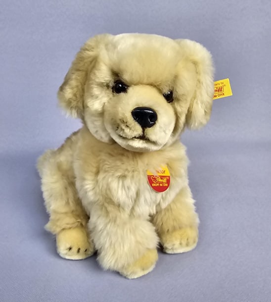 Steiff Golden Retriever Plush Toy A modern Steiff Golden Retriever plush toy, serial number 080654.: A modern Steiff Golden Retriever plush toy, serial number 080654. Realistically styled as a sitting Golden Retriever puppy with light golden-brown fur, dark eyes, and a black nose. Its covering is com