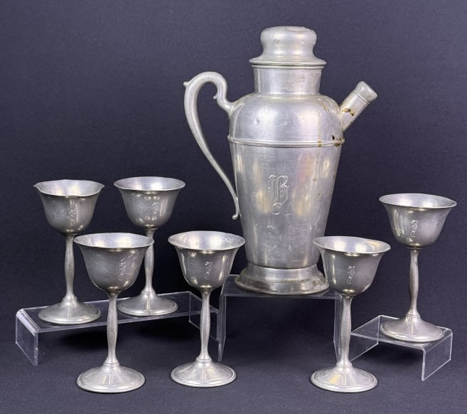 Vintage Pewter Cocktail Shaker & Goblets With "B" on each.: With "B" on each. 6 Goblets measuring 5.5 x 3 inches. One has bends. All have scuffs and scratches. Shaker measures 10.75 inches tall x 8 x 5 inches. See photos for condition details.