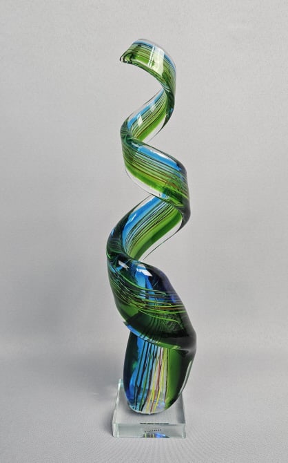 Murano Art Glass Multicolored Spiral Ribbon: Sculpture Sculpture stands 15 inches tall, showcasing a unique and artistic design. Made from glass with a colorful spiral ribbon motif, this sculpture exudes a whimsical and creative charm. Sticker o