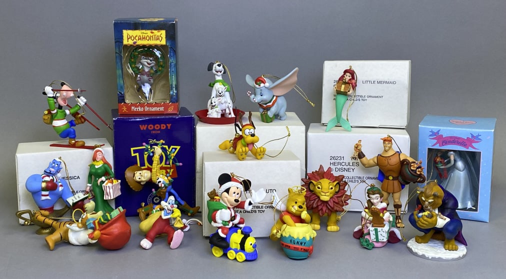 18 Collectible Character Christmas Ornaments including Jessica and Roger Rabbit. Lot also includes: including Jessica and Roger Rabbit. Lot also includes Meeko, Cinderella, Woody, Goofy, Beast, Belle, Hercules, Simba, Ariel, Pooh, Pluto, 101 Dalmatians, Tigger, Aladdin, Dumbo, and Mickey on train. G