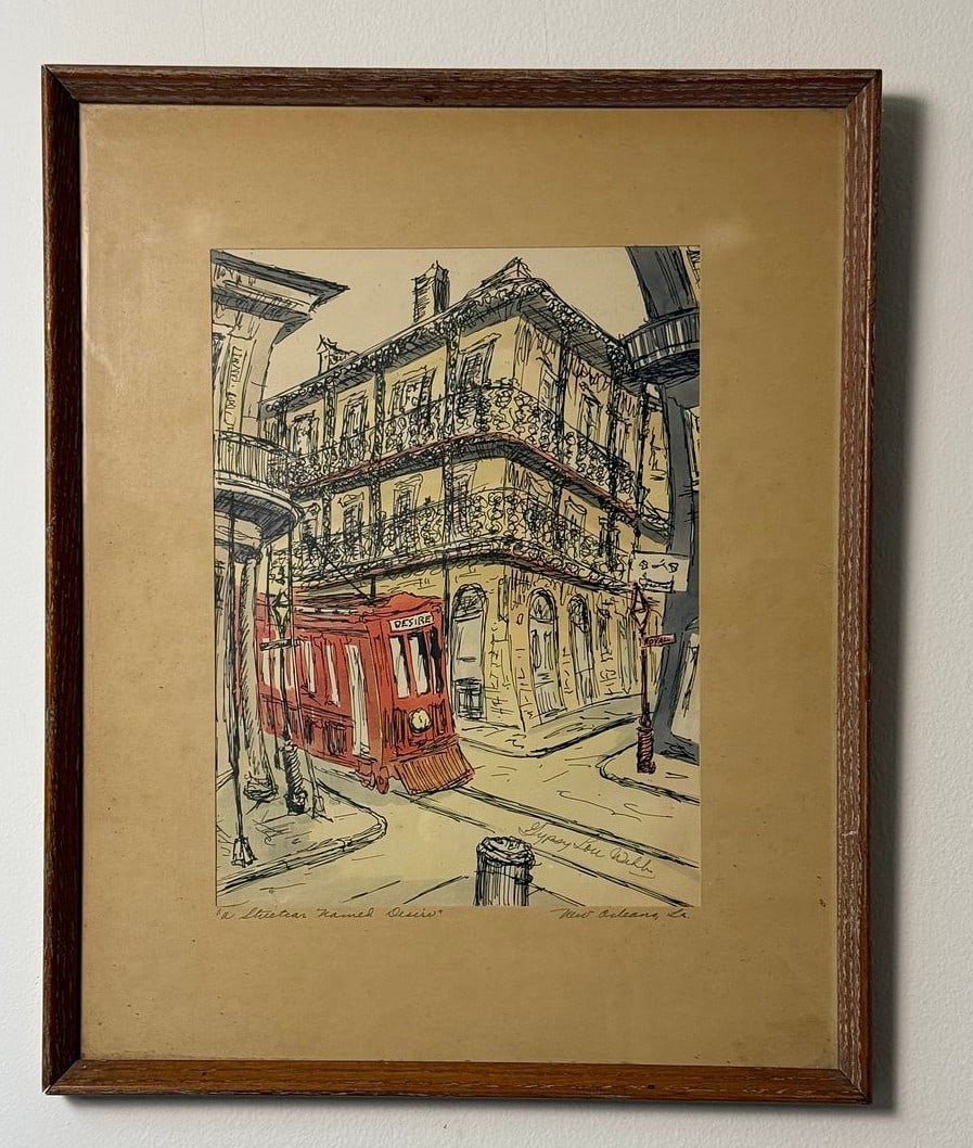Gypsy Lou Webb (American, 20th Century) 'A Streetcar Named Desire' Ink and Wash Illustration: An ink and wash illustration by Gypsy Lou Webb, titled 'A Streetcar Named Desire'. This framed artwork depicts a New Orleans street scene, centered on a red streetcar prominently labeled "DESIRE" and 