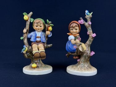 A Pair of Goebel M.I. Hummel 'Apple Tree Boy' and 'Apple Tree Girl' Figurines