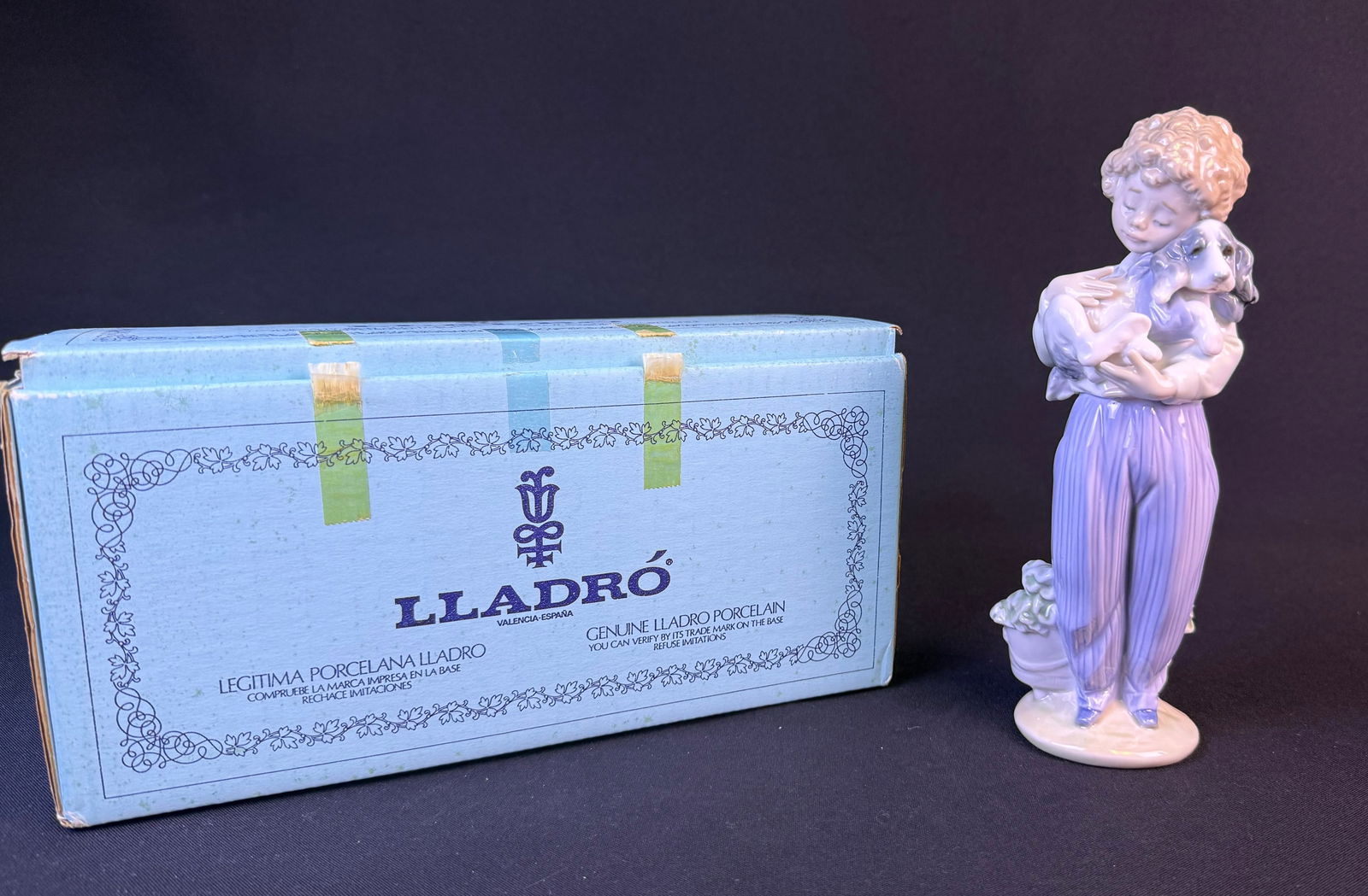 Lladro 'My Buddy' Figurine, No. 7609, Collectors Society 1989, with Original Box: A Lladro glazed porcelain figurine titled 'My Buddy', item number 7609, produced for the Collectors Society in 1989. The figurine depicts a young boy with light blonde curly hair, wearing a white shir