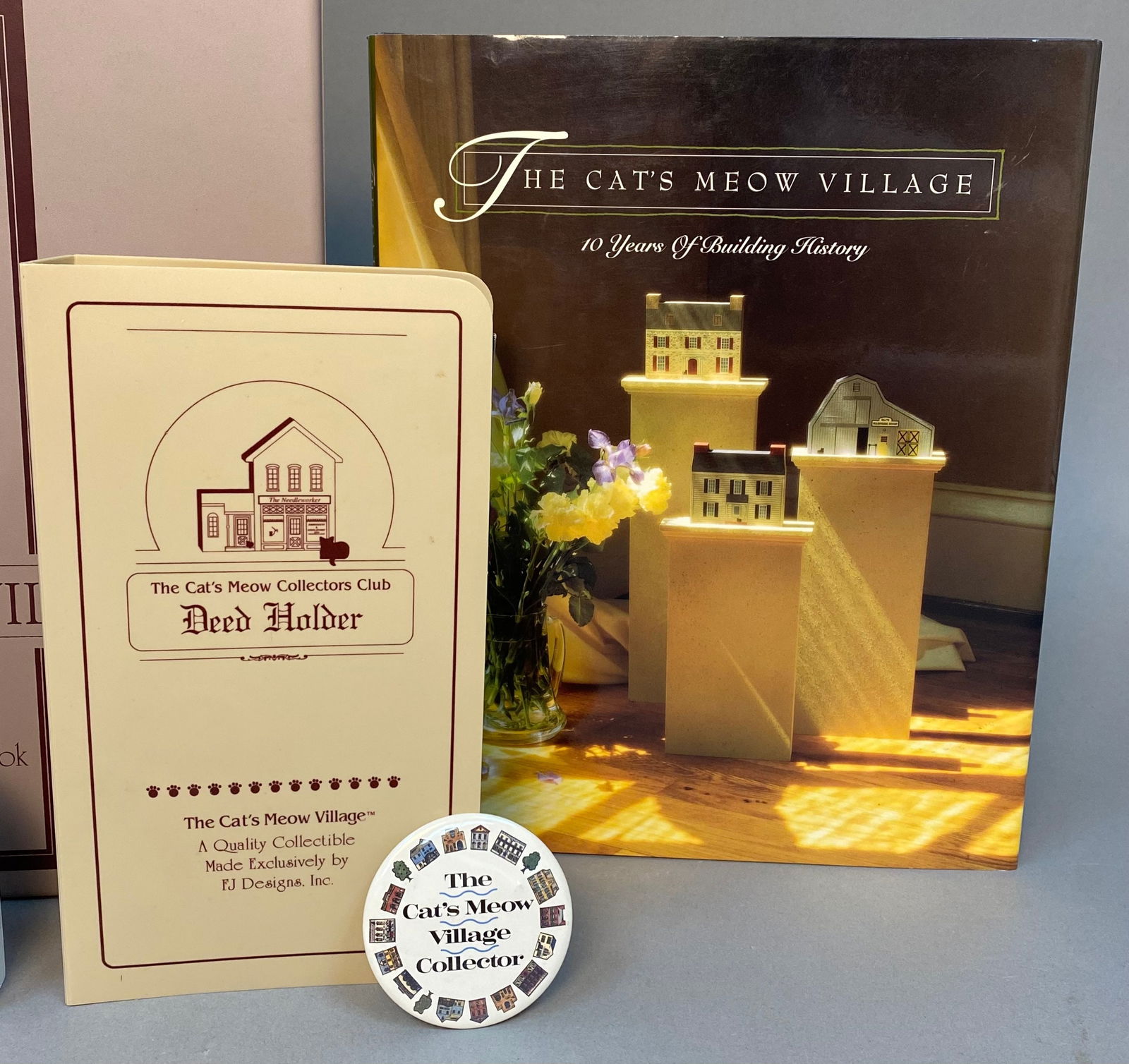 A Collection of The Cat's Meow Village Handcrafted Decorative Objects and Ephemera: A collection of 'The Cat's Meow Village' handcrafted decorative objects. Primarily made of painted wood or wood composite, these folk art style pieces feature miniature architectural replicas of histo