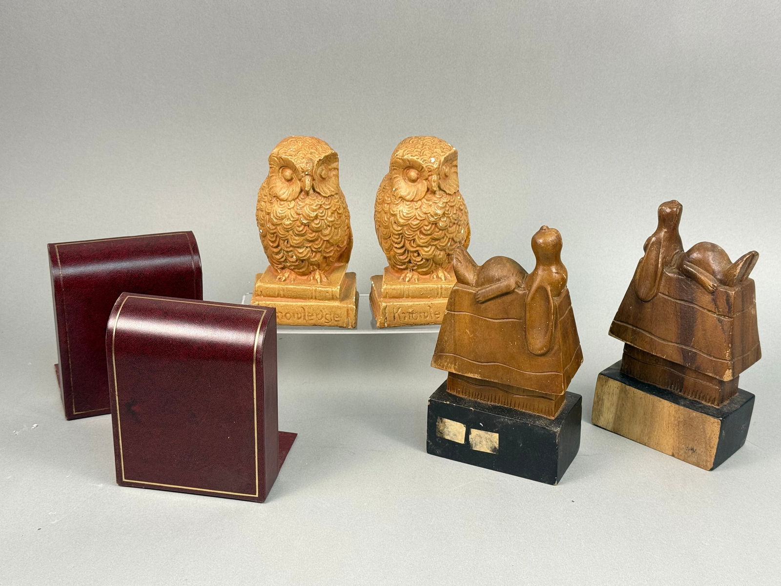 Assorted Bookends Snoopy Owls Leather: A lot comprising three pairs of bookends. The first pair features stylized owl figures, likely crafted from painted plaster or chalkware, each standing on a base inscribed with the word "Knowledg