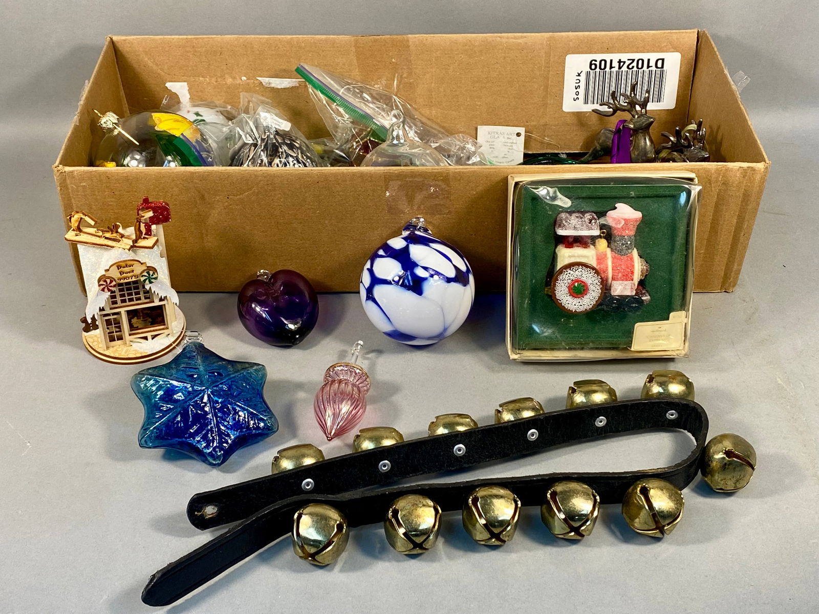 A Collection of Thomas Pacconi Classics Blown Glass Christmas Ornaments, a GingerCottages 'Polar: This varied collection of contemporary holiday decorations predominantly features multiple blown glass Christmas ornaments attributed to Thomas Pacconi Classics. The ornaments are in diverse shapes, i
