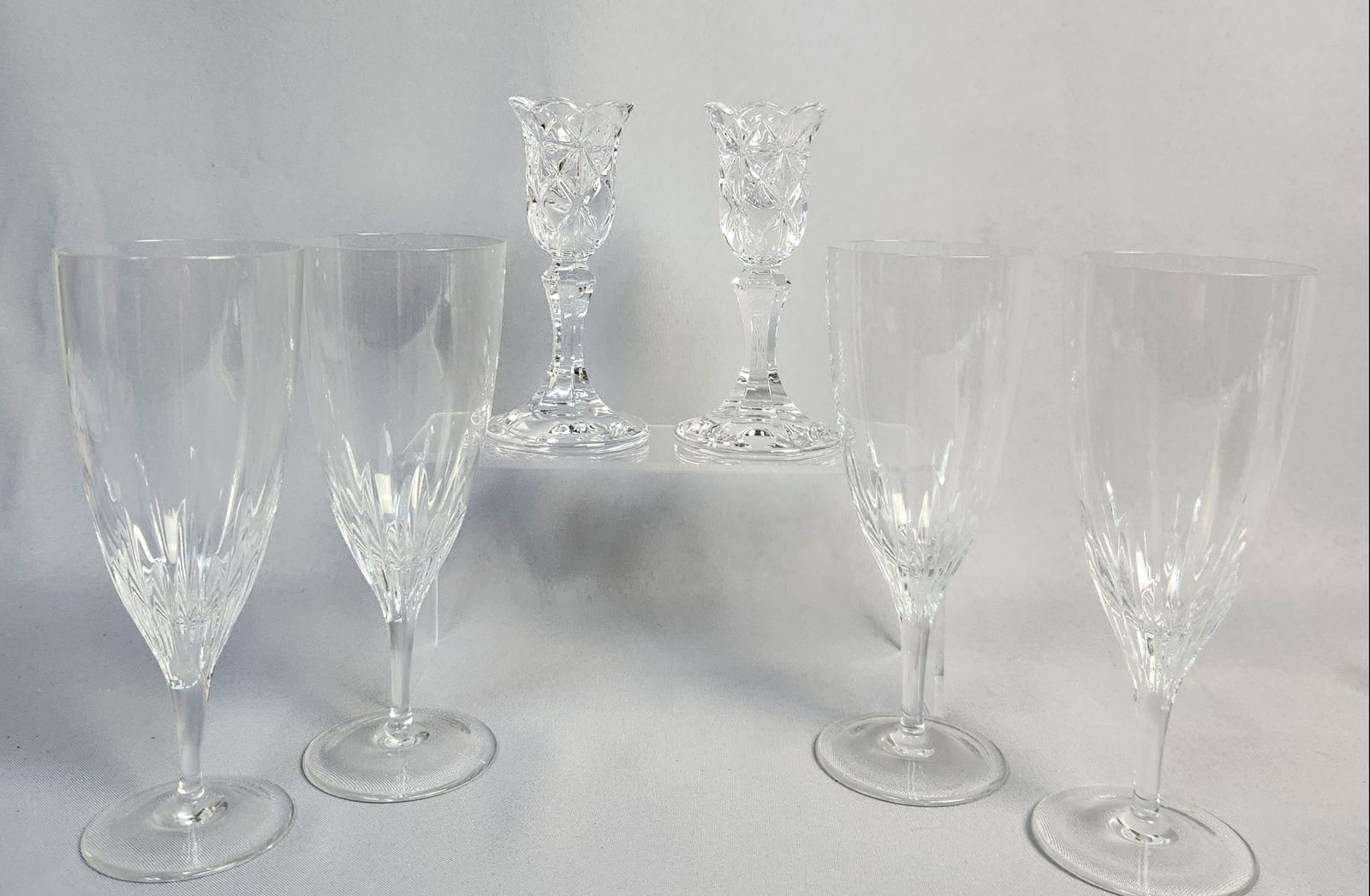 Six Marquis by Waterford Crystal Ice Tea Glasses & Marquis by Waterford Amway Candlesticks: A set of six cut crystal pieces by Marquis by Waterford. Comprising two smaller decorative items, likely votive holders or bud vases, each featuring a scalloped rim and intricate diamond-cut patterns