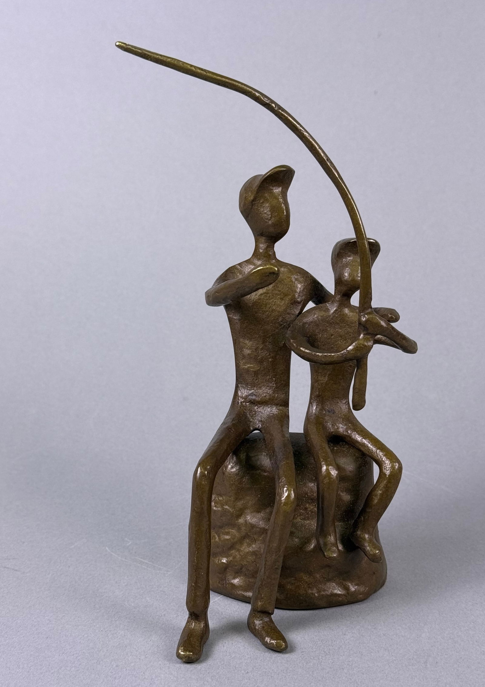 An Abstract Bronze Sculpture of Two Figures with a Rod (1 of 5)