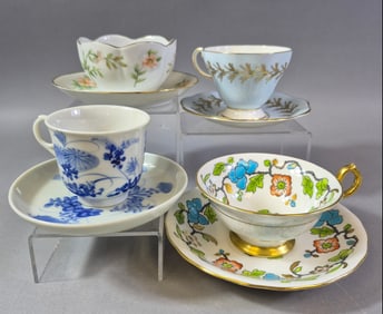 A Collection of Four Assorted Porcelain and Bone China Cup and Saucer Sets