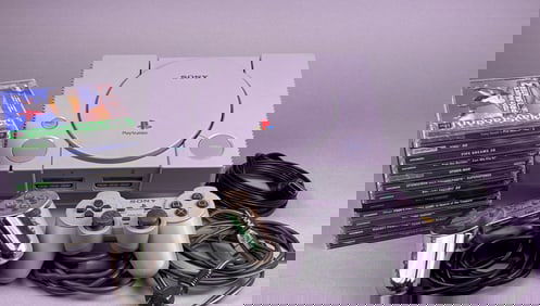 Sony PlayStation 1 Console with Two Controllers and A Group of Games