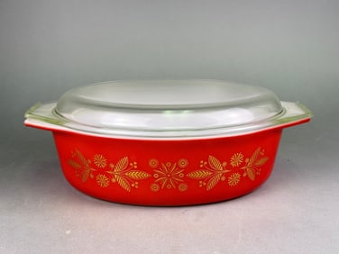 A Pyrex 'Golden Poinsettias' 2 1/2 Quart Oval Casserole with Lid